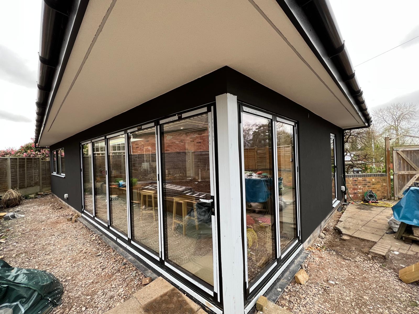Rear extension finished in black silicone render