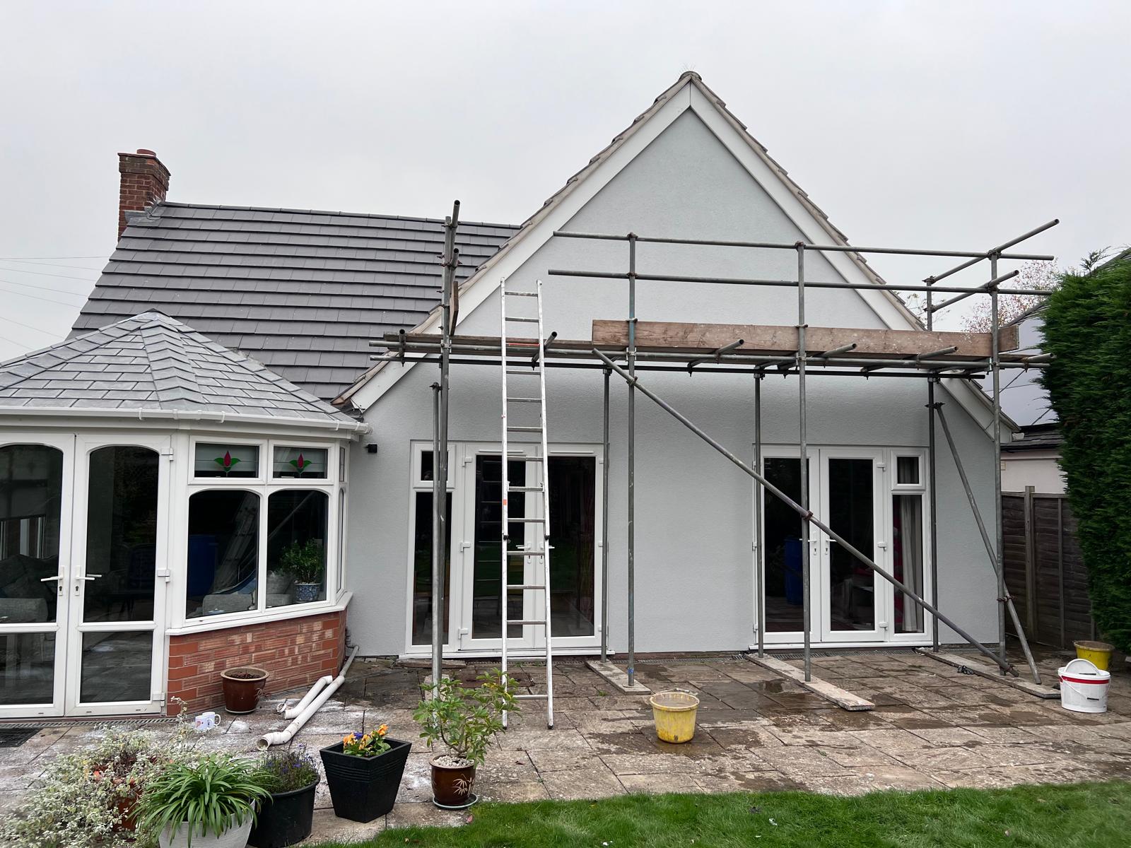 Bungalow rear elevation with conservatory, finished in fresh white render